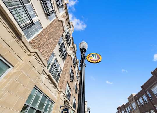a sign on a pole in front of a building at Providence at Old Meridian Apartments , Carmel, Indiana