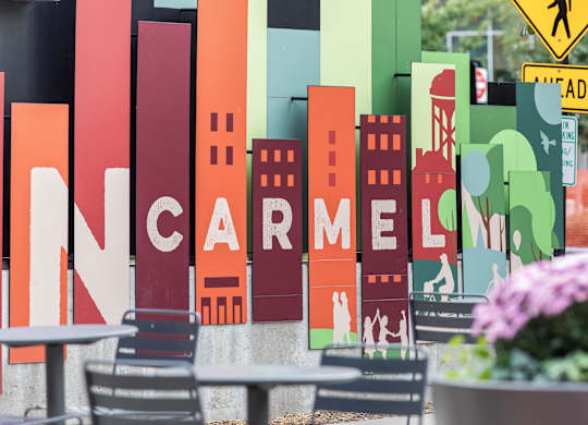 a sign for a restaurant with a city skyline on it at Providence at Old Meridian Apartments , Indiana