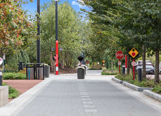 a city sidewalk with trees and a stop sign at Providence at Old Meridian Apartments , Carmel, IN, 46032