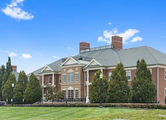 a large brick building with a green lawn and trees at Providence at Old Meridian Apartments , Indiana