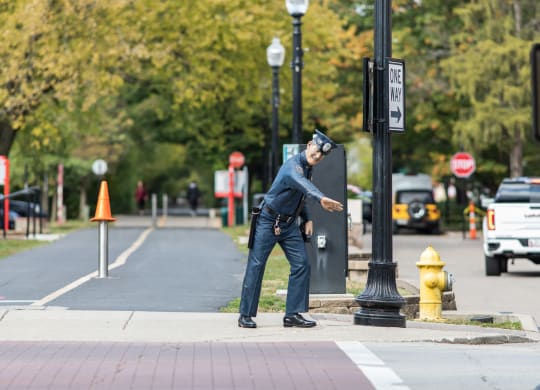 a police officer is standing on the curb of a street
