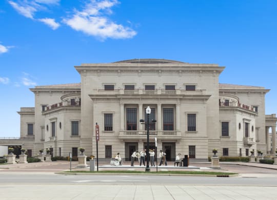 a large white building with people standing in front of it