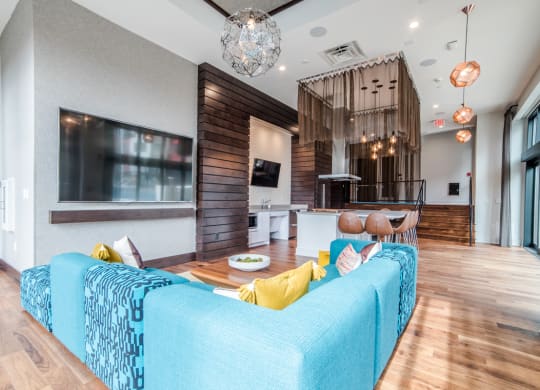 Indoor lounge area with TV, display kitchen, bar seating, theater seating and connected to outdoor pool