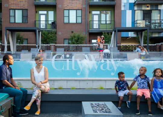 Outdoor gathering spot in front of infinity pool with benches, fire pits, grills and more