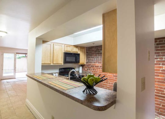 Modular Kitchen with Black Appliances wide view and Living room wide view at Lockerbie Court on Mass Ave, Indianapolis, IN