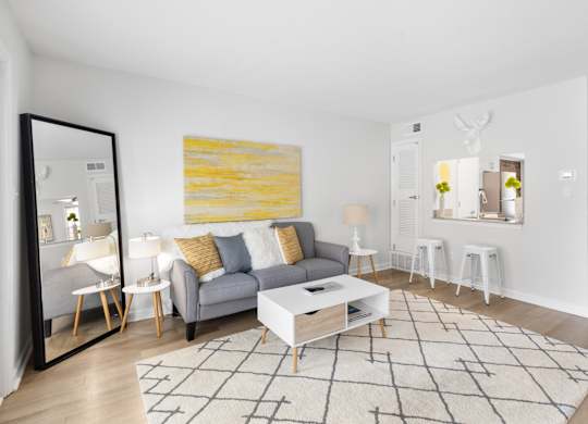 Stylish apartment living space at Monon Living in the heart of Broad Ripple with cozy seating, open breakfast bar, and walkable access to the Monon Trail.