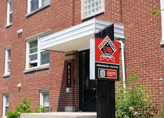 Close-up of leasing signage for Monon Court apartments at 6131 E 61st St, part of the Monon Living portfolio in Broad Ripple