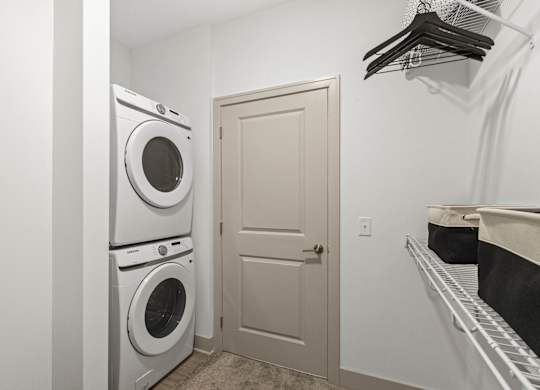 a washer and dryer in a laundry room with a white door