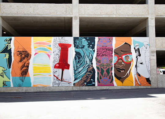 a mural on the side of a building in a parking garage