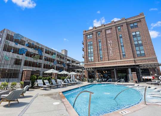 a swimming pool in front of a brick building