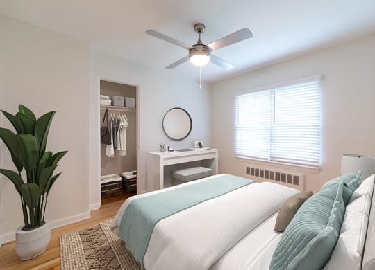 a bedroom with a bed and a ceiling fan