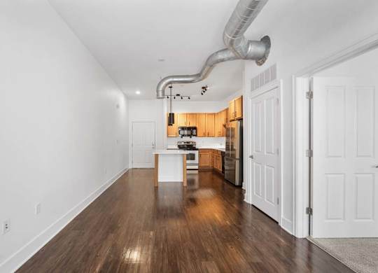 A long, narrow hallway with a kitchen area at The Foundry, South Bend, IN