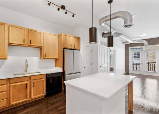 A kitchen with wooden cabinets and a white countertop.at The Foundry, South Bend, 46617