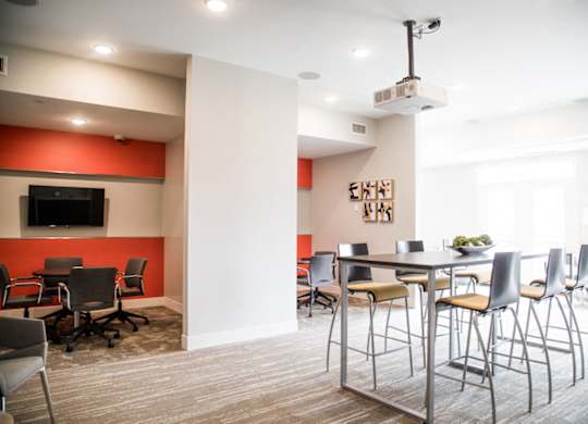 a conference room with a table and chairs and a tv at The Foundry, South Bend, IN 46617