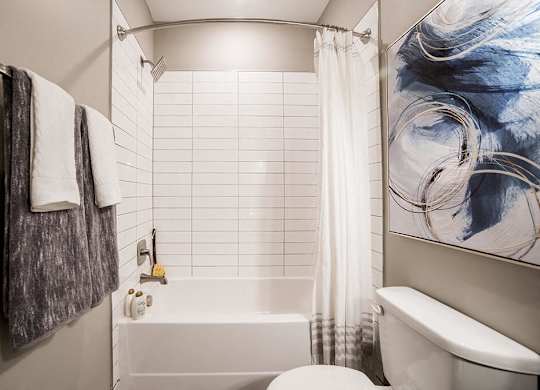 a bathroom with a white tub and a toilet at The Foundry, South Bend