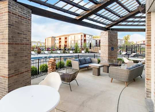 a patio with furniture and a pool at aria on the strip apartments at Echo Park at Perry Crossing Apartments, Plainfield, IN