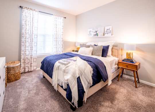 Bedroom with cozy bed and lamp interior at Providence at Old Meridian Apartments , Indiana 46032