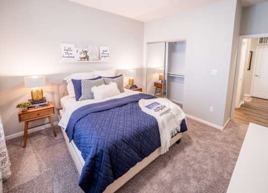 Bedroom with cozy bed and lamp at Providence at Old Meridian Apartments , Indiana