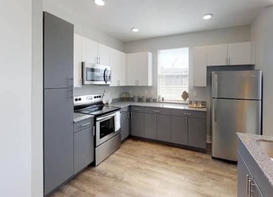a kitchen with stainless steel appliances and white cabinets at Echo Park at Perry Crossing Apartments, Indiana, 46168
