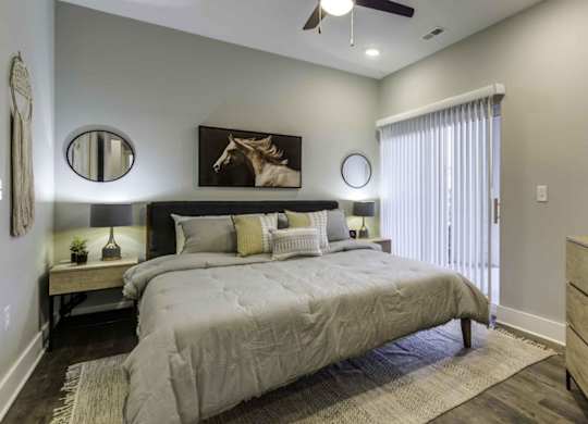 bedroom with bed and night stands with large window at Echo Park at Perry Crossing Apartments, Plainfield