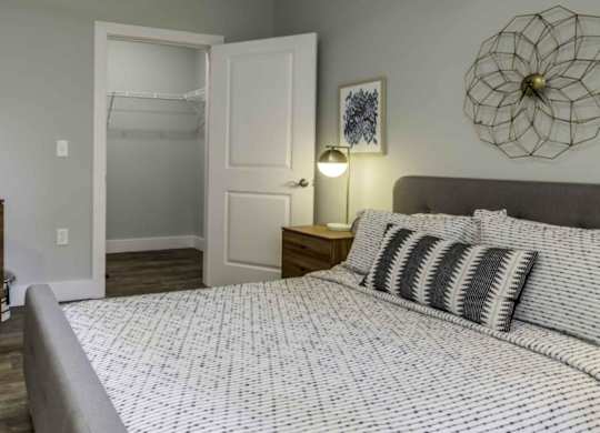 a bedroom with a bed and a closet at Echo Park at Perry Crossing Apartments, Plainfield, IN, 46168
