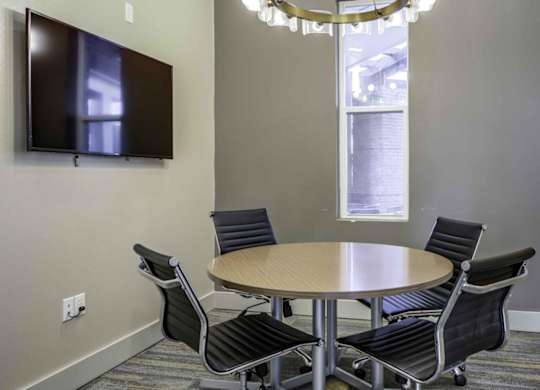 a conference room with a round table and chairs at Echo Park at Perry Crossing Apartments, Plainfield