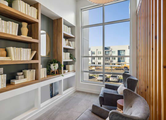 a living room with bookshelves and a large window at 38° NORTH, Santa Rosa