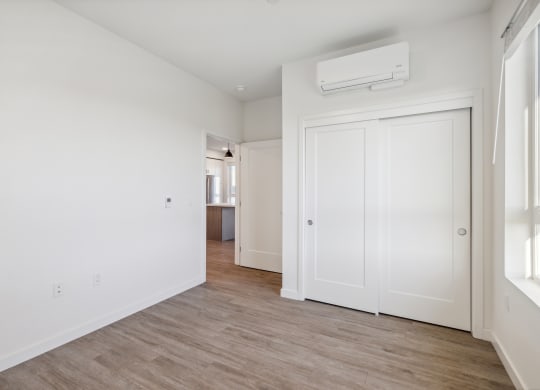 an empty living room with white walls and wood flooring at 38° NORTH, Santa Rosa 