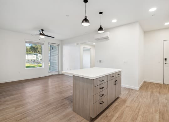 the living room and kitchen in a new home with white walls and wood flooring at 38° NORTH, Santa Rosa