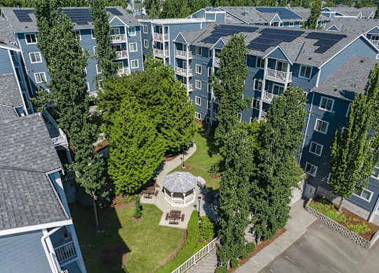 A bird's eye view of a residential area with a gazebo in the center.