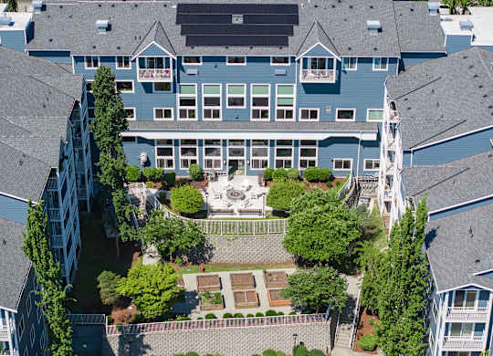 A large blue building with a courtyard in the middle.