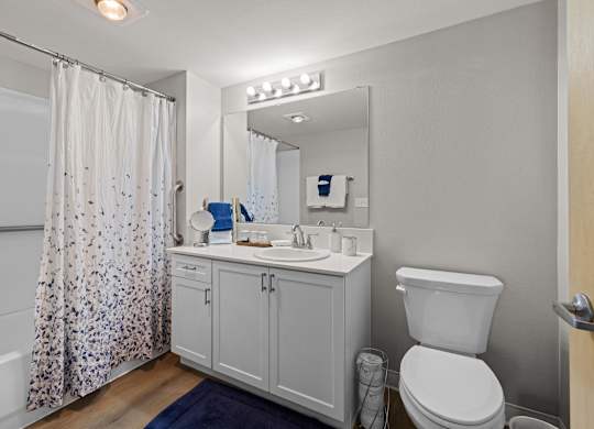 A white toilet sits next to a sink in a bathroom.