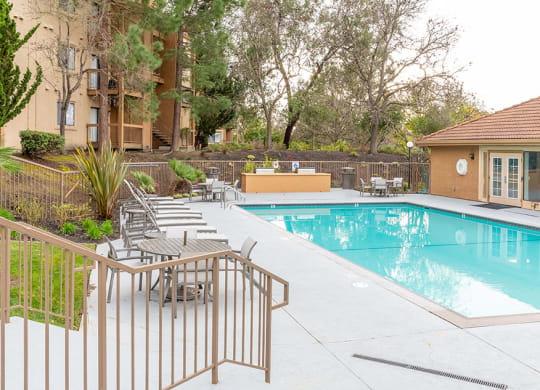 Pool with lounge chairs at Bella Vista at Hilltop Apartments, California, 94806
