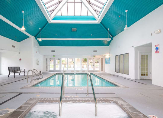 Indoor Pool with lounge chairs at Bella Vista at Hilltop Apartments, California, 94806