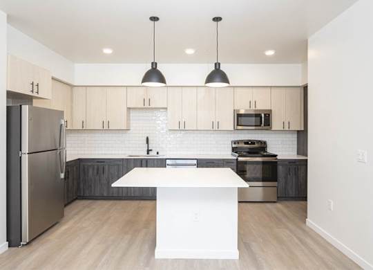 A modern kitchen with a white island in the middle. at 38° NORTH, Santa Rosa, CA, 95404