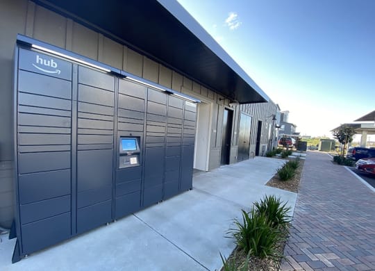 a row of lockers outside a building with a blue sky in the background