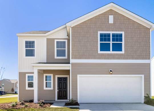 a tan house with a white garage door