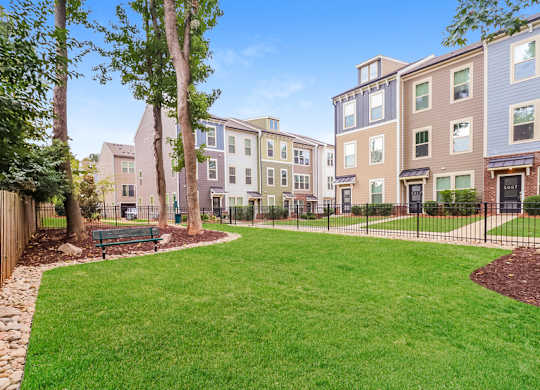 A grassy area in front of apartment buildings.