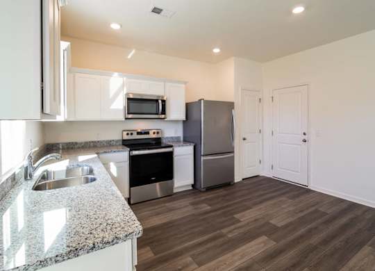 a kitchen with stainless steel appliances and a granite counter top