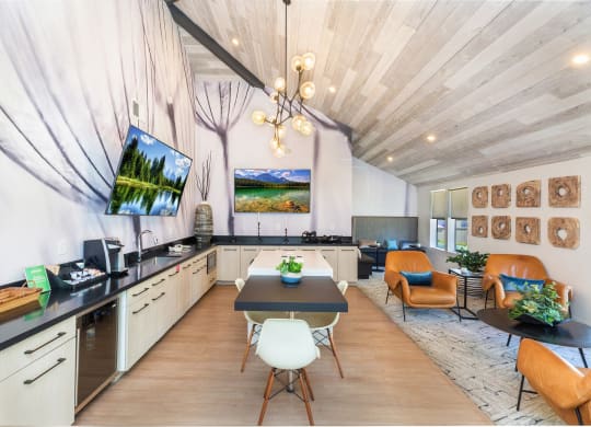a dining room with a table and chairs and a kitchen and living room