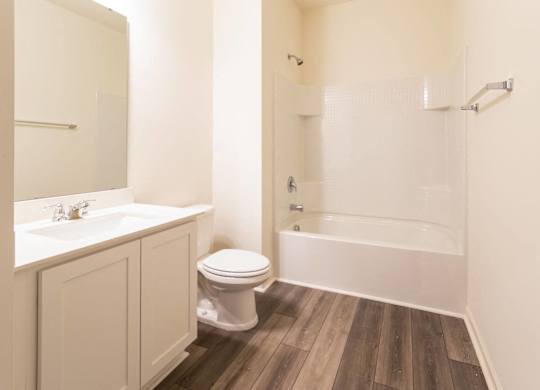 a bathroom with a toilet and a tub and a sink