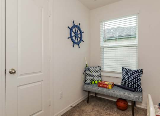 Sitting room with nautical decor, bench, and games.