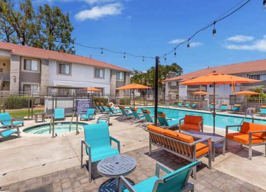our apartments have a resort style pool with lounge chairs and umbrellas
