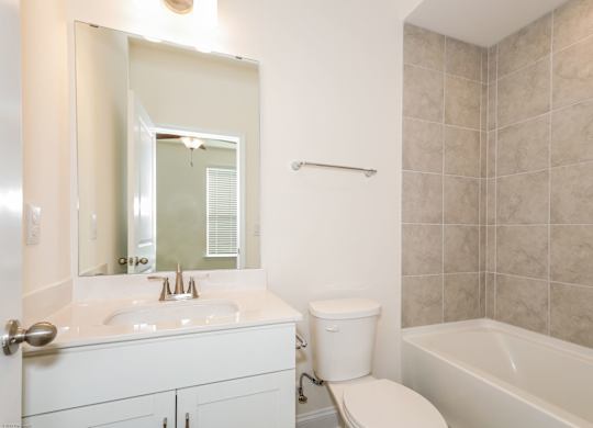 Charlotte NC Luxury Apartments for Rent - Loso Walk - Bathroom With Vinyl Plank Flooring, Vanity Sink, Toilet, And Shower With Tub Combo.