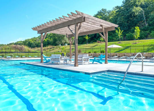 a swimming pool with a pavilion next to a pool