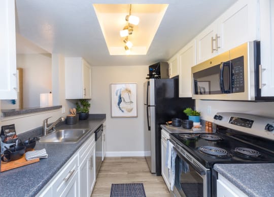 a spacious kitchen with stainless steel appliances and granite counter tops