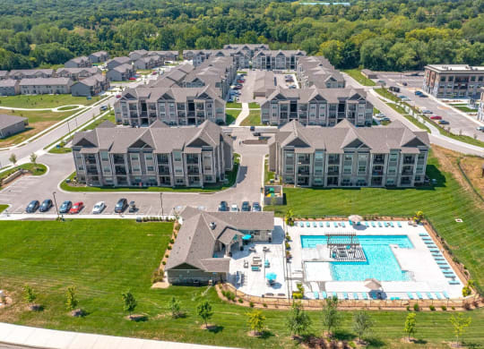 an aerial view of an apartment complex with a swimming pool
