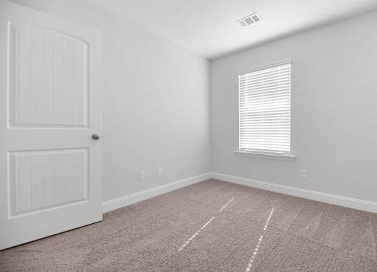 Cottonvale Towns in Savannah, GA photo of guest bedroom with plus carpeting and a window