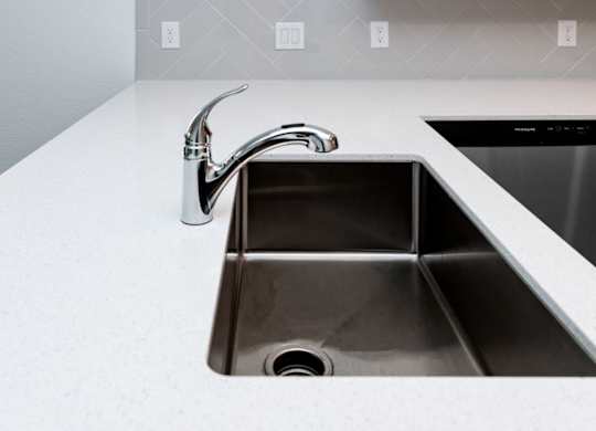 a kitchen sink with a faucet
