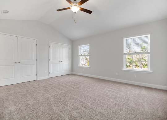 Cottonvale Towns in Savannah, GA photo of bedroom with plush carpeting and ceiling fan